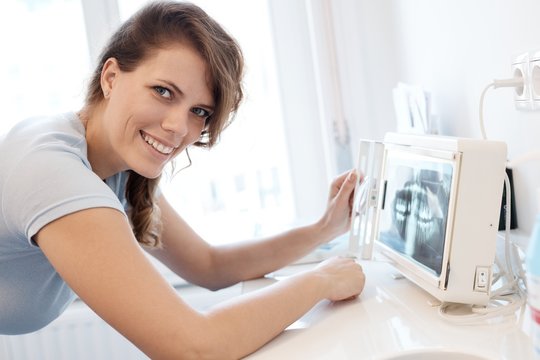 Female dental surgeon with x-ray image