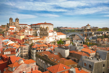 Fototapeta na wymiar Panorama of the historic center with red tile roofs and the Don Luis Bridge in Porto Portugal a sunny spring day