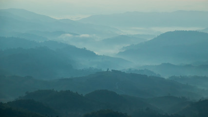 mountains valley with the sea of fog and clouds.Layers of mountains in morning sunrise.
