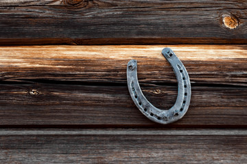 Old horseshoe on an old wooden board. The concept of luck, luck, luck.