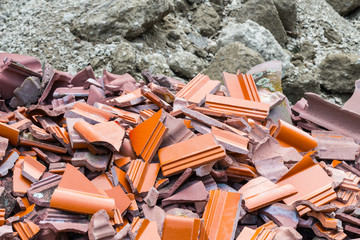Cracked roof tile. Rubble heap. Building waste dump detail. Pile of broken ceramic pieces and...