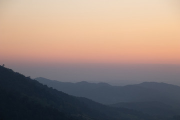 Fototapeta premium Mountain fog in morning sunrise landscape.beautiful view of mountain range in the mist background.Mountain valley texture in chiang rai northern province of thailand
