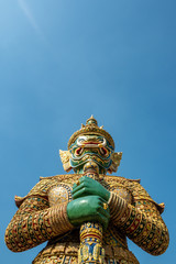 The beautiful emerald giant statue on clear blue sky background