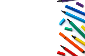 Many colorful markers on white background, top view. Rainbow palette