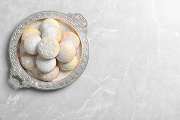 Dish of traditional cookies for Islamic holidays on table, top view with space for text. Eid Mubarak