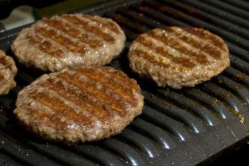 four steaks on an electric grill close up
