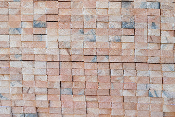 A pile of boards in a carpentry shop. Wood prepared for production in an industrial plant. Light background.