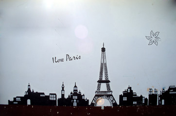 Wall with drawings of Paris. White wall with drawn Eiffel tower
