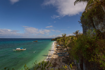 Fototapeta na wymiar exotic rocky beach and coastline with blue and turquoise water, crystal clear water, a tropical tranquil relaxing scene