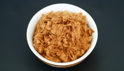 Rousong or beef floss on black background.