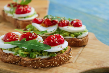 avocado toasts with boiling egg arugula cherry tomatoes sesame seeds healthy snack 
