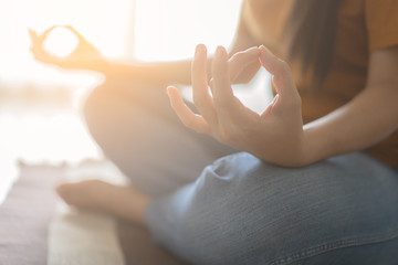 Close up hand and half body of healthy woman sit in lotus Yoga position.Young healthy woman sitting...