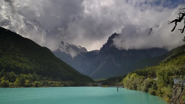 4k timelapse of rainy clouds into the valley at Blue Moon Lake, Lijiang, China during autumn.