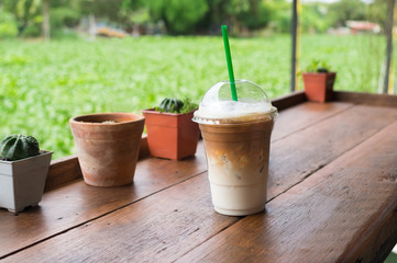 Iced coffee glass on wood table.