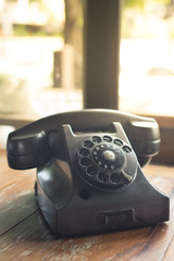 Old retro telephone on table.