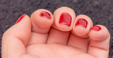 Closeup photo of a beautiful female hands with red nails