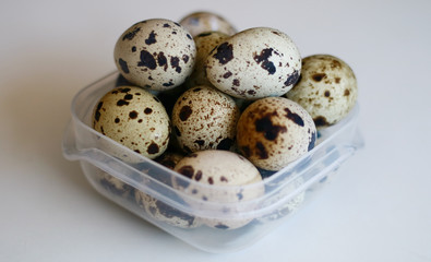 Quail Eggs on white background. Quail eggs help to improve metabolism, reduce blood pressure,...