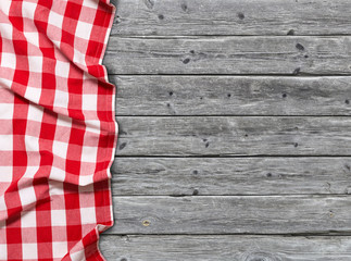 Red checkered tablecloth on wooden background