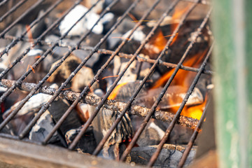 Grill charcoal burning with an open flame isolated 