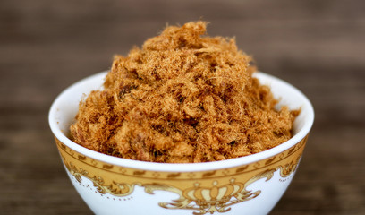 Rousong or beef floss on wood background.