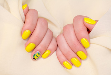 Beautiful yellow nails manicure. Light manicure in light on a white background.
