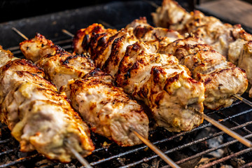 Traditional shashlik cooking on a grill isolated