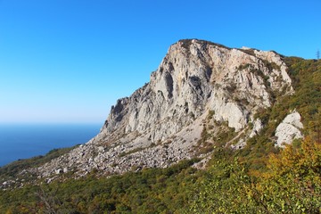 View of Foros Mountain above the autumn forest on the Crimean Peninsula. It's an unofficial name of the left part of Mshatka-Kaya mountain which indeed looks like an independent mountain.