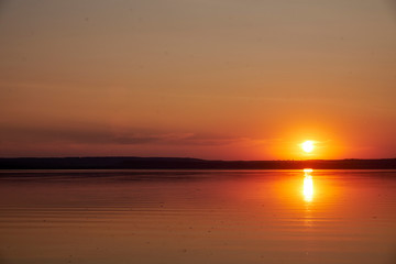 Fototapeta premium Sunset on the lake without waves