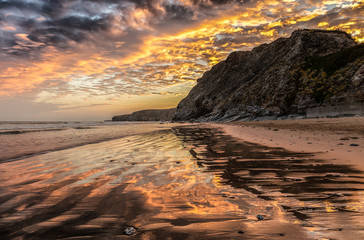 Bunter, feuerroter Morgenhimmel am Strand von Watergate Beach, einem Surfer Hot Spot in Cornwall