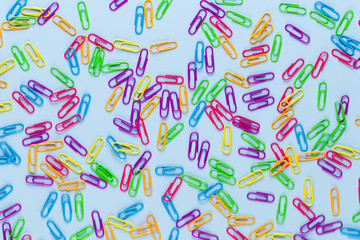 Paper color clip notebook on blue background. Flat lay.