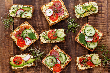 Sandwiches with cream cheese, vegetables and salami.