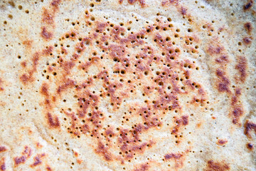 close-up of baked pancake made from rye flour, textured background