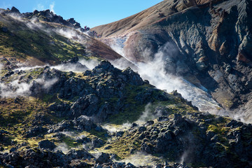 Iceland geothermal zone - area in mountains with hot springs. Cracks in mountains with hot steam.Tourist and natural attractions.