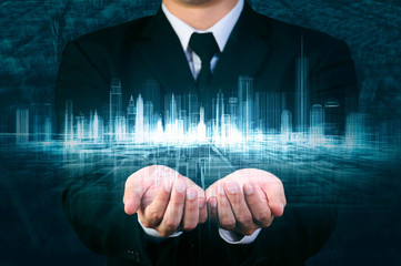 businessman holding glow wireframe cityspace