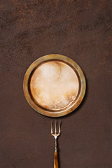 Background with vintage metal plate and fork