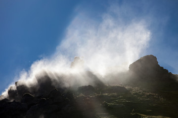 Iceland geothermal zone - area in mountains with hot springs. Cracks in mountains with hot steam.Tourist and natural attractions.