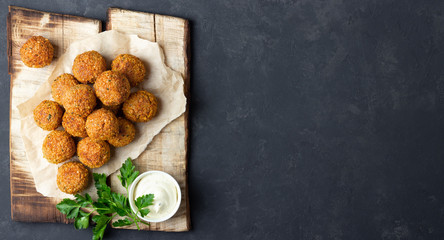 Vegetarian chickpeas falafel balls on wooden rustic board. Traditional Middle Eastern and arabian...