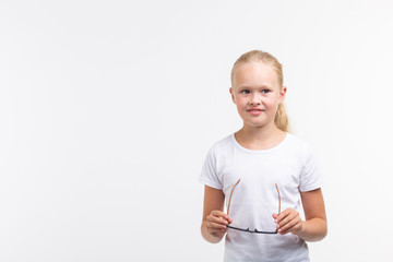 Beautiful child girl with glasses on white background with copy space