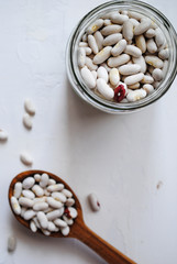 White beans in a wooden spoon