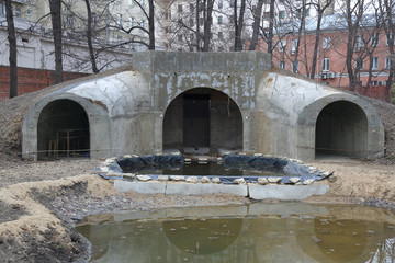 Unfinished bomb shelter made of durable concrete in a city block