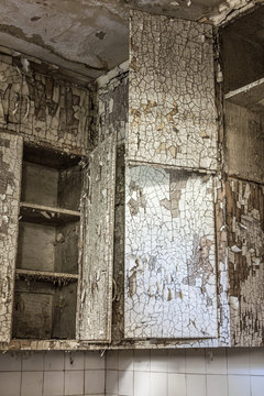 Interesting patterns in the peeling paint of these kitchen cabinets in a long abandoned housing project apartment building