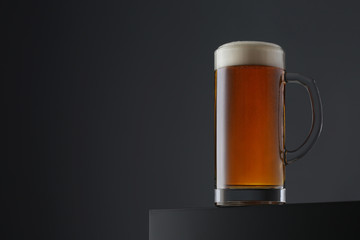 Mug of beer on dark grey background