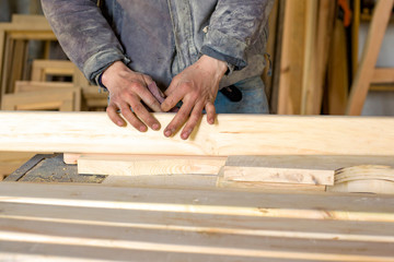 hand polished board by a carpenter; woodworker working in a workshop