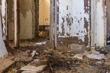 Lots of debris on the floor of this long abandoned housing project apartment building