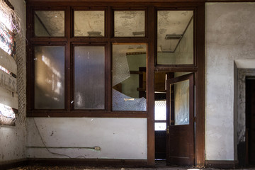 Old fashioned office with broken windows left abandoned