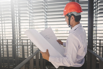 Consultant engineer discussing construction project in blueprint; Consulting concept in construction at office indoor