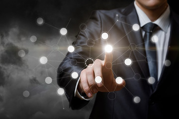 A businesswoman touching a digital networking system button.