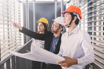 Consultant engineer discussing construction project in blueprint; Consulting concept in...