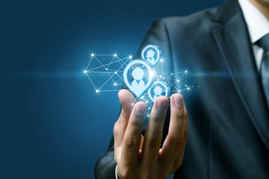 A hand of a businessman holding a structure of potential clients structure.