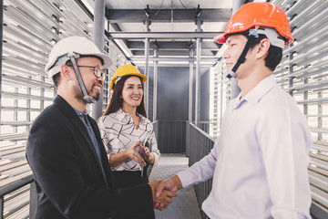 Consultant engineer discussing construction project in blueprint; Consulting concept in...